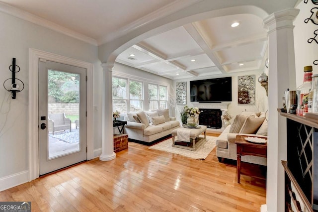 3085 Saint Andrews Dr, Duluth, GA 30096 - living area featuring decorative columns, healthy amount of natural light, arched walkways, light wood finished floors, and beamed ceiling