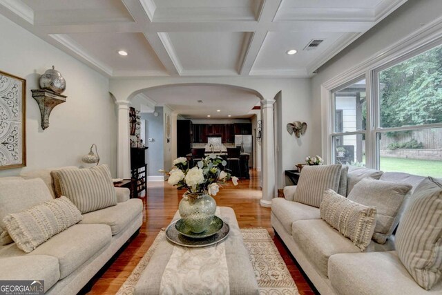 3085 Saint Andrews Dr, Duluth, GA 30096 - living area with decorative columns, arched walkways, light wood finished floors, coffered ceiling, and beam ceiling