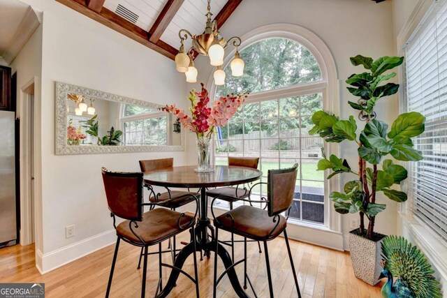 3085 Saint Andrews Dr, Duluth, GA 30096 - dining room featuring beamed ceiling, light wood finished floors, a chandelier, baseboards, and high vaulted ceiling