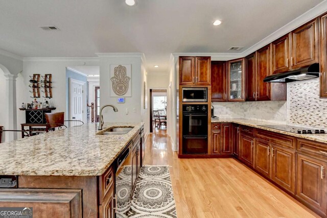 3085 Saint Andrews Dr, Duluth, GA 30096 - kitchen featuring a sink, black appliances, under cabinet range hood, light wood-style floors, and light stone counters