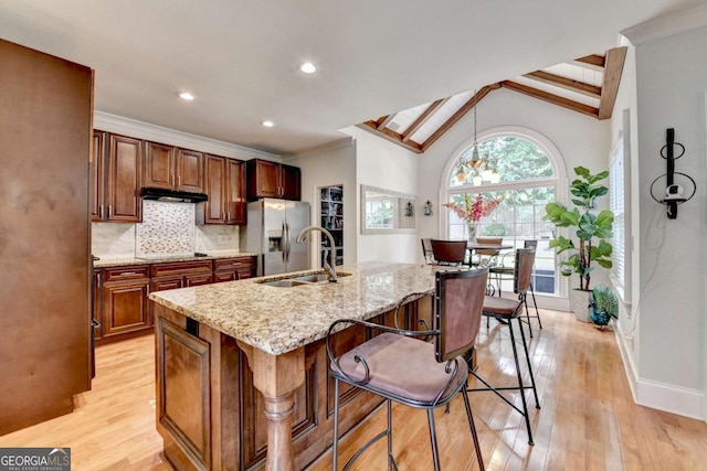 3085 Saint Andrews Dr, Duluth, GA 30096 - kitchen featuring stainless steel refrigerator with ice dispenser, a sink, under cabinet range hood, a kitchen bar, and electric stovetop