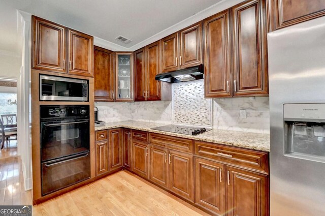 3085 Saint Andrews Dr, Duluth, GA 30096 - kitchen with stainless steel appliances, under cabinet range hood, light stone countertops, and light wood-style flooring