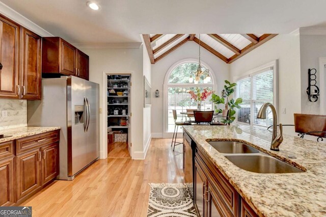 3085 Saint Andrews Dr, Duluth, GA 30096 - kitchen with a sink, stainless steel fridge, light wood finished floors, backsplash, and light stone counters