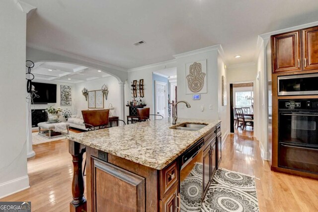 3085 Saint Andrews Dr, Duluth, GA 30096 - kitchen with a sink, black appliances, arched walkways, light wood-style floors, and ornamental molding