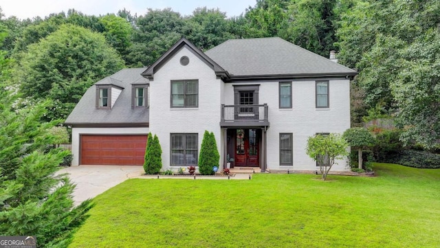 3085 Saint Andrews Dr, Duluth, GA 30096 - view of front of property with concrete driveway, a front lawn, brick siding, a chimney, and a balcony