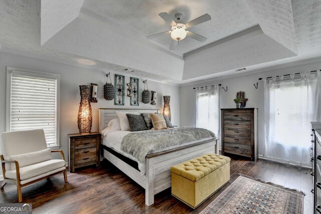 3085 Saint Andrews Dr, Duluth, GA 30096 - bedroom with a tray ceiling, dark wood-type flooring, a textured ceiling, and ceiling fan