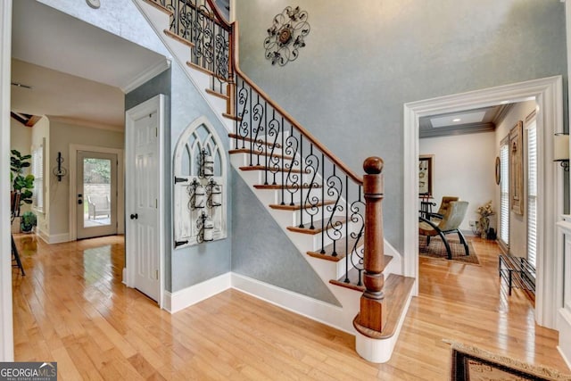 3085 Saint Andrews Dr, Duluth, GA 30096 - stairs featuring ornamental molding, wood finished floors, baseboards, plenty of natural light, and a high ceiling