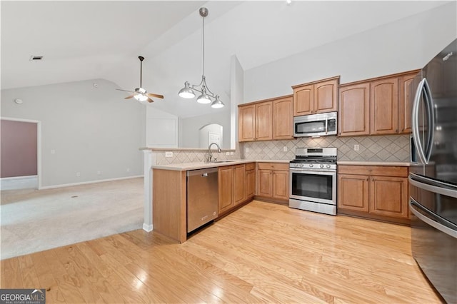607 Little Shoals Ct, Canton, GA 30115 - kitchen with appliances with stainless steel finishes, a ceiling fan, vaulted ceiling, a peninsula, and light countertops