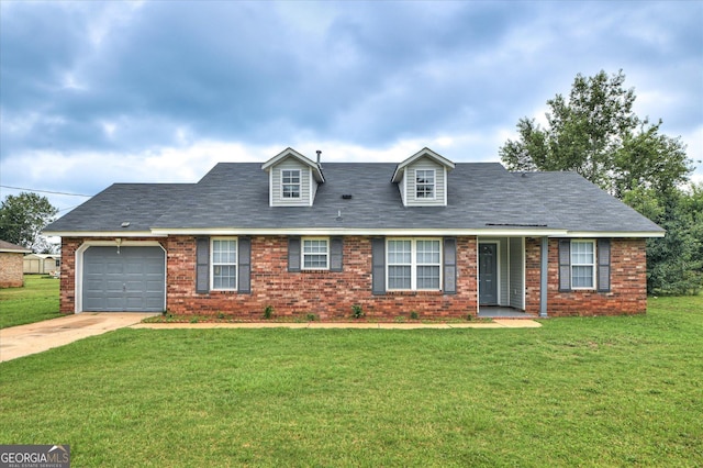 2011 Mims Rd, Hephzibah, GA 30815 - cape cod-style house with an attached garage, concrete driveway, a front yard, and brick siding