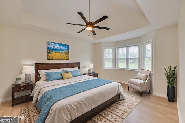 2011 Mims Rd, Hephzibah, GA 30815 - bedroom with a tray ceiling, light wood finished floors, and a ceiling fan