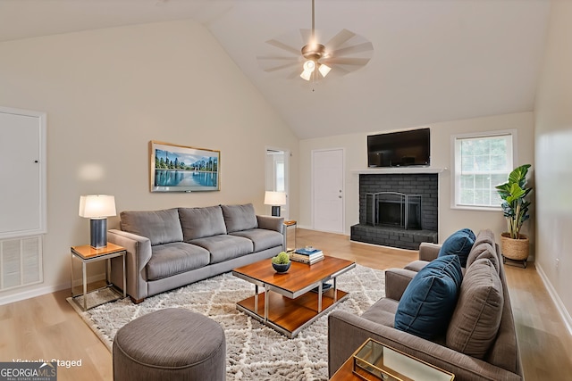 2011 Mims Rd, Hephzibah, GA 30815 - living area with high vaulted ceiling, a ceiling fan, wood finished floors, and a brick fireplace