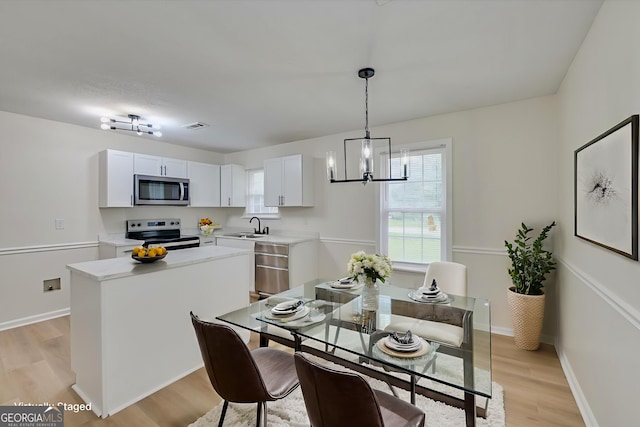 2011 Mims Rd, Hephzibah, GA 30815 - dining space with a chandelier and light wood-style floors