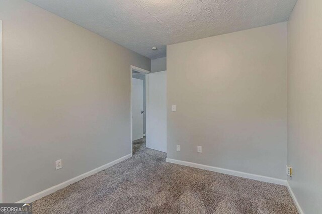 2139 Jonathan Ave, Lithonia, GA 30058 - carpeted empty room featuring a textured ceiling and baseboards