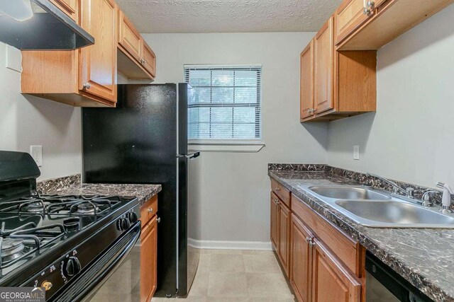 2139 Jonathan Ave, Lithonia, GA 30058 - kitchen featuring black gas range oven, under cabinet range hood, a sink, dark countertops, and stainless steel dishwasher