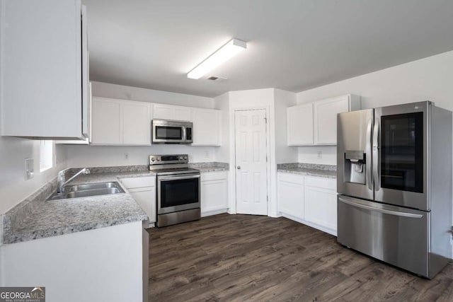 761 Riverside Dr NW, Calhoun, GA 30701 - kitchen featuring stainless steel appliances, white cabinets, dark wood finished floors, and light countertops
