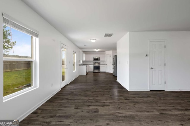 761 Riverside Dr NW, Calhoun, GA 30701 - unfurnished living room with baseboards and dark wood-type flooring