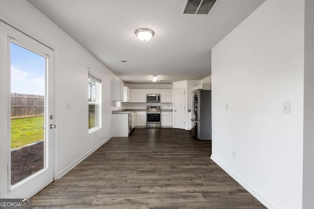 761 Riverside Dr NW, Calhoun, GA 30701 - kitchen with stainless steel appliances, white cabinetry, dark wood-style floors, and light countertops