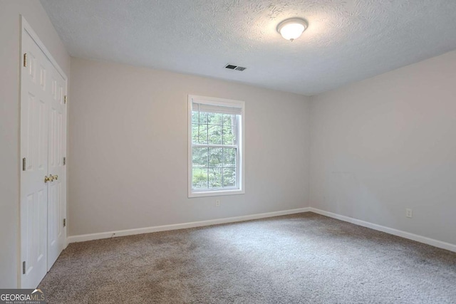 2140 Deer Trl, Suwanee, GA 30024 - carpeted spare room featuring a textured ceiling and baseboards
