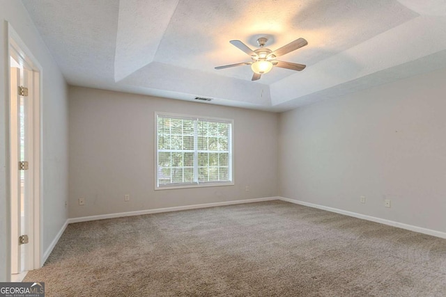 2140 Deer Trl, Suwanee, GA 30024 - carpeted spare room featuring a tray ceiling, ceiling fan, baseboards, and a textured ceiling