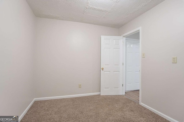 2140 Deer Trl, Suwanee, GA 30024 - unfurnished room featuring carpet floors, a textured ceiling, and baseboards