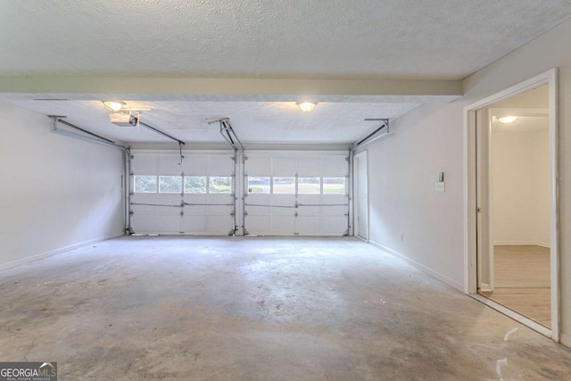 2140 Deer Trl, Suwanee, GA 30024 - garage with a garage door opener and baseboards