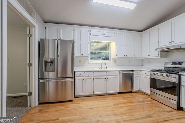 2140 Deer Trl, Suwanee, GA 30024 - kitchen featuring stainless steel appliances, under cabinet range hood, a sink, light countertops, and white cabinets