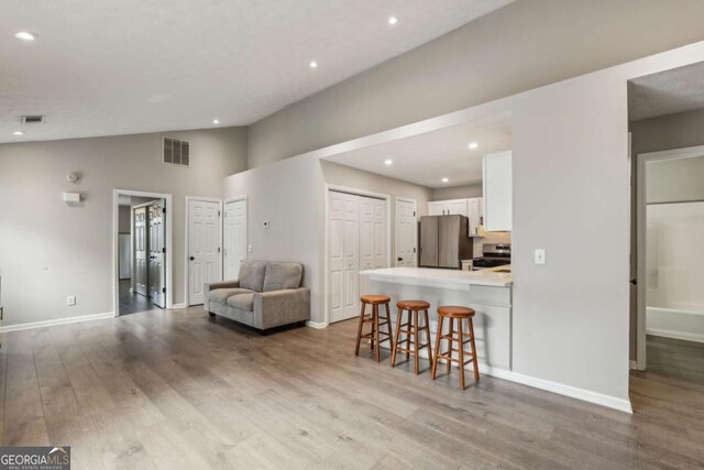 2657 Albion Farm Way, Duluth, GA 30097 - living area with wood finished floors, baseboards, recessed lighting, and lofted ceiling