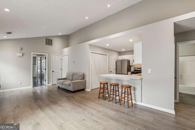 2657 Albion Farm Way, Duluth, GA 30097 - living room featuring wood finished floors, recessed lighting, and vaulted ceiling