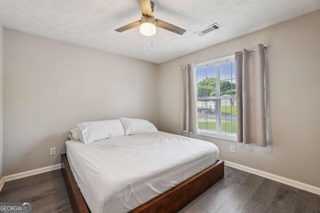 2657 Albion Farm Way, Duluth, GA 30097 - bedroom with baseboards, wood finished floors, a ceiling fan, and a textured ceiling