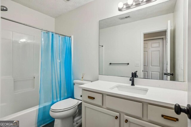 2657 Albion Farm Way, Duluth, GA 30097 - full bathroom featuring vanity, toilet, a textured ceiling, and shower / tub combo with curtain