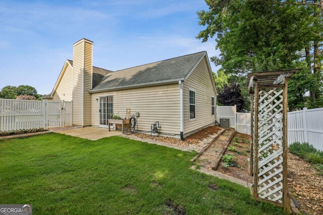 2657 Albion Farm Way, Duluth, GA 30097 - rear view of house with a chimney, a gate, a shingled roof, a patio area, and central AC