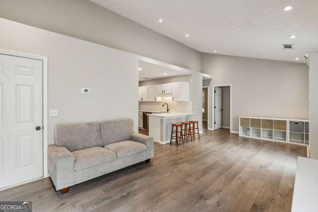 2657 Albion Farm Way, Duluth, GA 30097 - living area with wood finished floors, recessed lighting, and lofted ceiling
