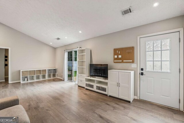 2657 Albion Farm Way, Duluth, GA 30097 - unfurnished living room featuring wood-type flooring, baseboards, lofted ceiling, and recessed lighting