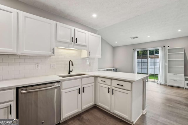2657 Albion Farm Way, Duluth, GA 30097 - kitchen with stainless steel dishwasher, a peninsula, backsplash, white cabinets, and dark wood-type flooring