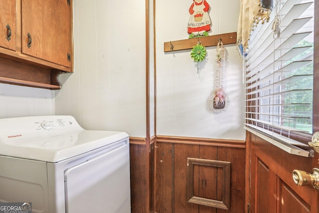 289 Hilton St, Monticello, GA 31064 - laundry room featuring washer / dryer, cabinet space, and wooden walls
