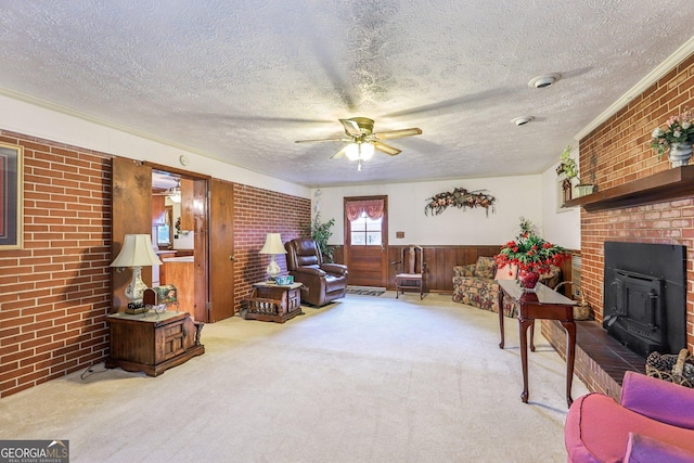 289 Hilton St, Monticello, GA 31064 - living room featuring brick wall, carpet floors, a textured ceiling, ceiling fan, and wood walls