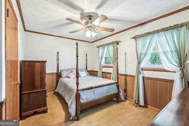 289 Hilton St, Monticello, GA 31064 - carpeted bedroom featuring wainscoting, a textured ceiling, wood walls, crown molding, and a ceiling fan