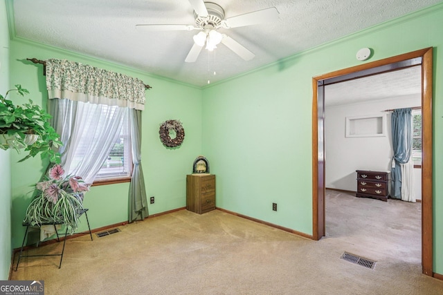 289 Hilton St, Monticello, GA 31064 - unfurnished room featuring carpet floors, crown molding, a textured ceiling, ceiling fan, and baseboards