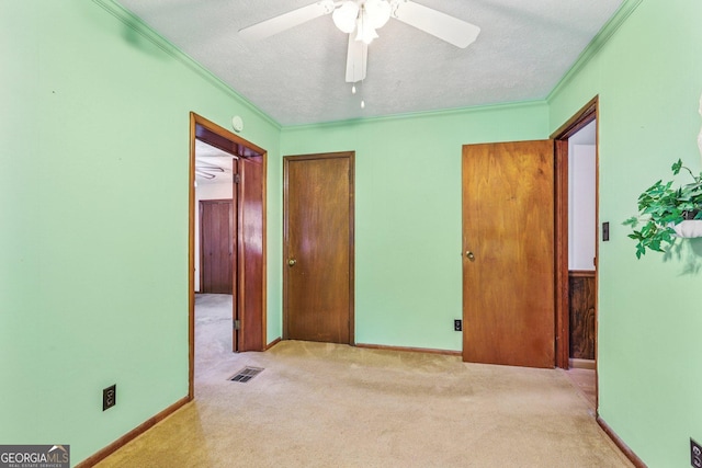 289 Hilton St, Monticello, GA 31064 - unfurnished bedroom featuring ornamental molding, carpet floors, a textured ceiling, a closet, and a ceiling fan