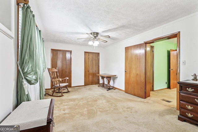 289 Hilton St, Monticello, GA 31064 - sitting room featuring carpet, ceiling fan, a textured ceiling, baseboards, and ornamental molding