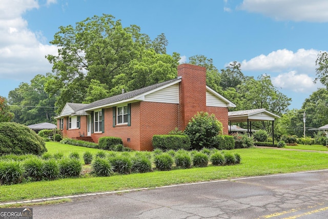 289 Hilton St, Monticello, GA 31064 - view of side of home with a yard, brick siding, and a chimney