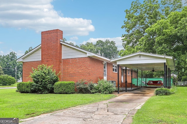 289 Hilton St, Monticello, GA 31064 - view of side of home featuring a yard, brick siding, a carport, and concrete driveway