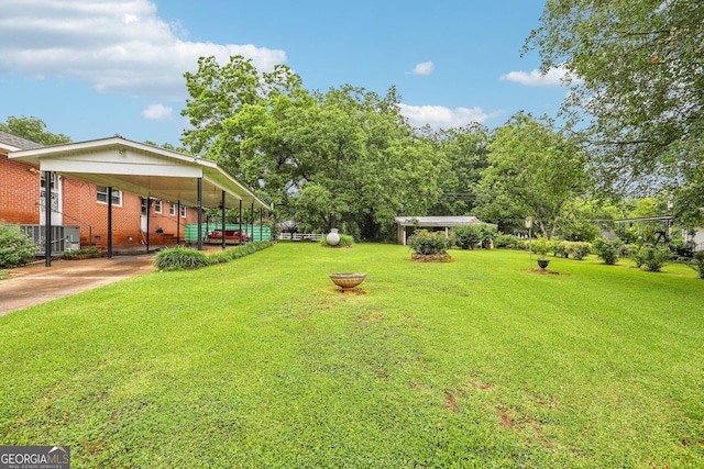 289 Hilton St, Monticello, GA 31064 - view of yard with concrete driveway and a carport