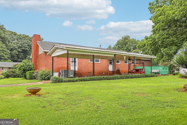 289 Hilton St, Monticello, GA 31064 - back of property with a lawn, a chimney, brick siding, central air condition unit, and crawl space