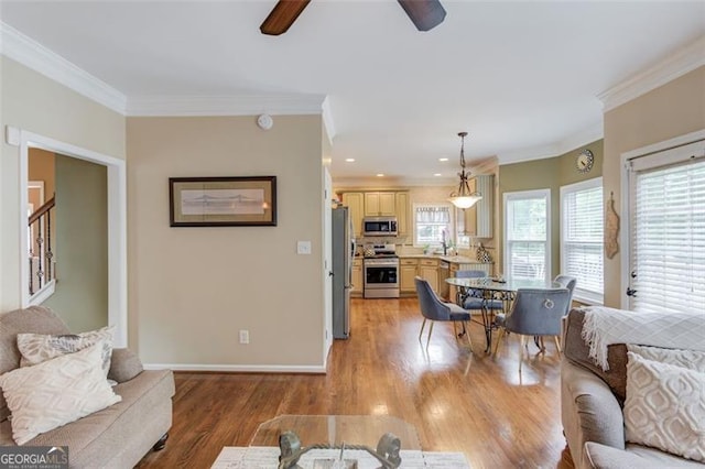 262 Sandhurst Ct, Suwanee, GA 30024 - living room featuring a ceiling fan, crown molding, light wood-style flooring, baseboards, and recessed lighting