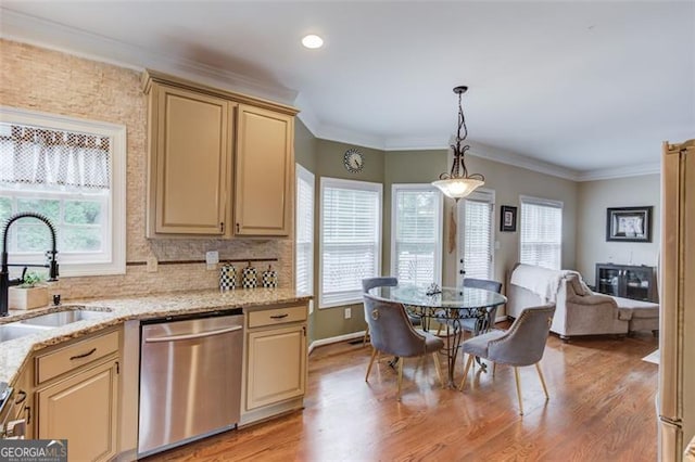 262 Sandhurst Ct, Suwanee, GA 30024 - kitchen featuring dishwasher, a sink, light wood finished floors, light stone counters, and decorative light fixtures