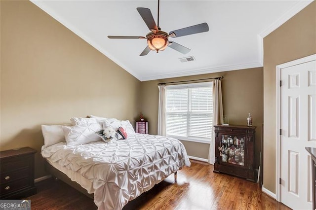 262 Sandhurst Ct, Suwanee, GA 30024 - bedroom featuring ornamental molding, baseboards, wood finished floors, lofted ceiling, and ceiling fan