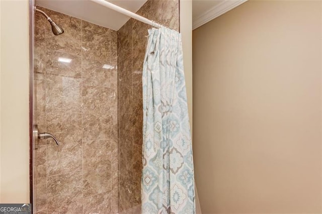 262 Sandhurst Ct, Suwanee, GA 30024 - bathroom featuring tiled shower and crown molding