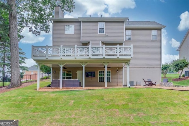 262 Sandhurst Ct, Suwanee, GA 30024 - rear view of house with a ceiling fan, a chimney, a balcony, and a patio area