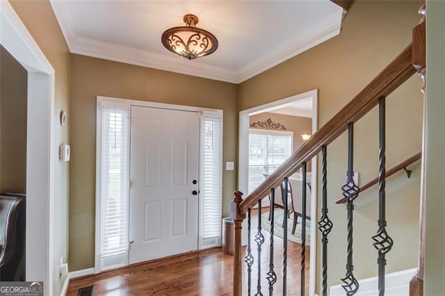 262 Sandhurst Ct, Suwanee, GA 30024 - foyer entrance featuring crown molding, wood finished floors, stairs, and baseboards